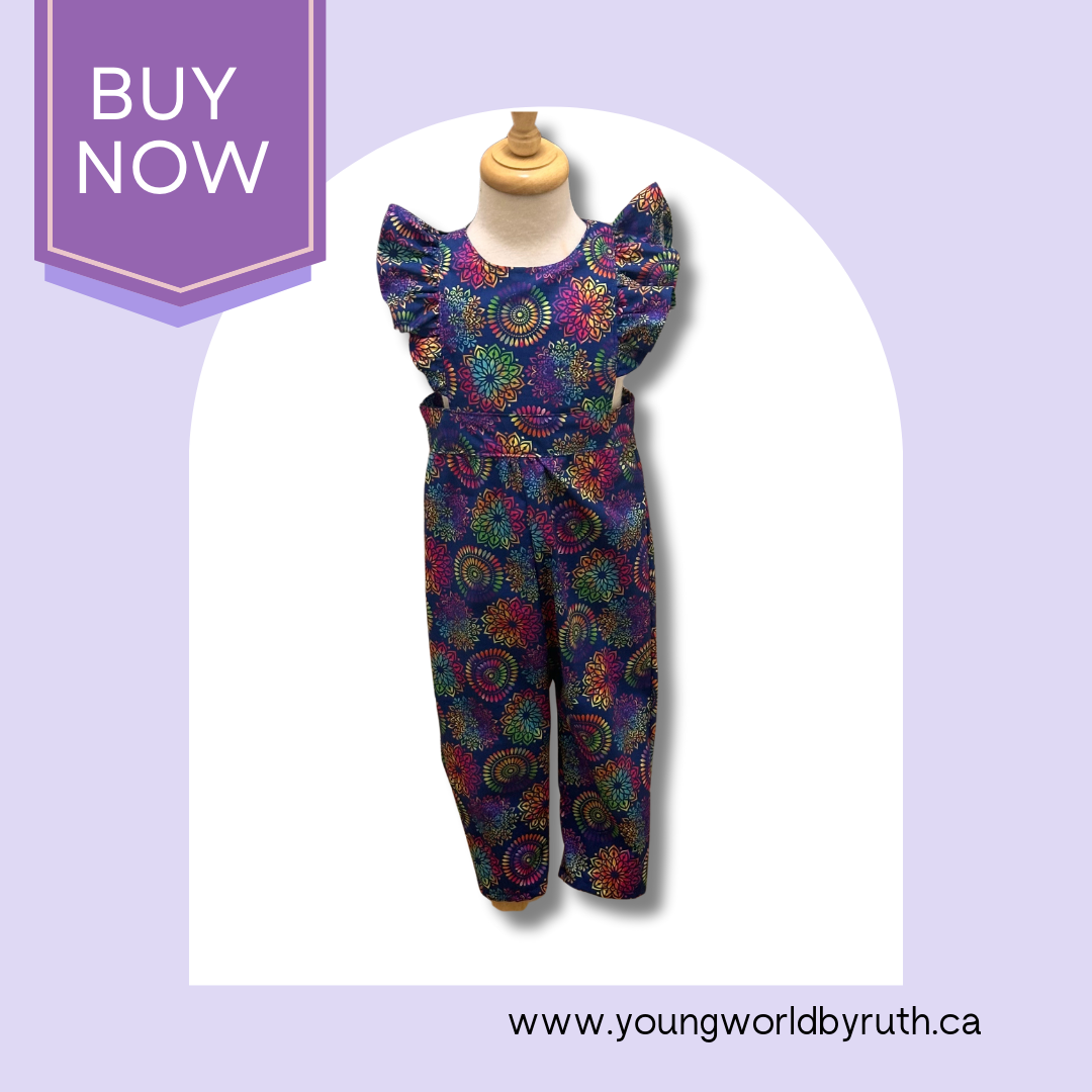 A child's jumpsuit featuring a vibrant geometric African print on cotton