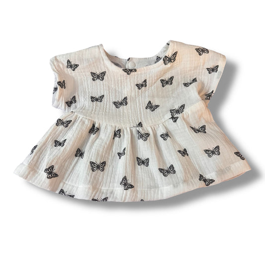 Handmade Baby dress with butterfly pattern on a white background