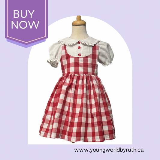 A Red and white checkered dress with a ruffle trim Peter Pan collar and pin-tucked front bodice, displayed on a mannequin.