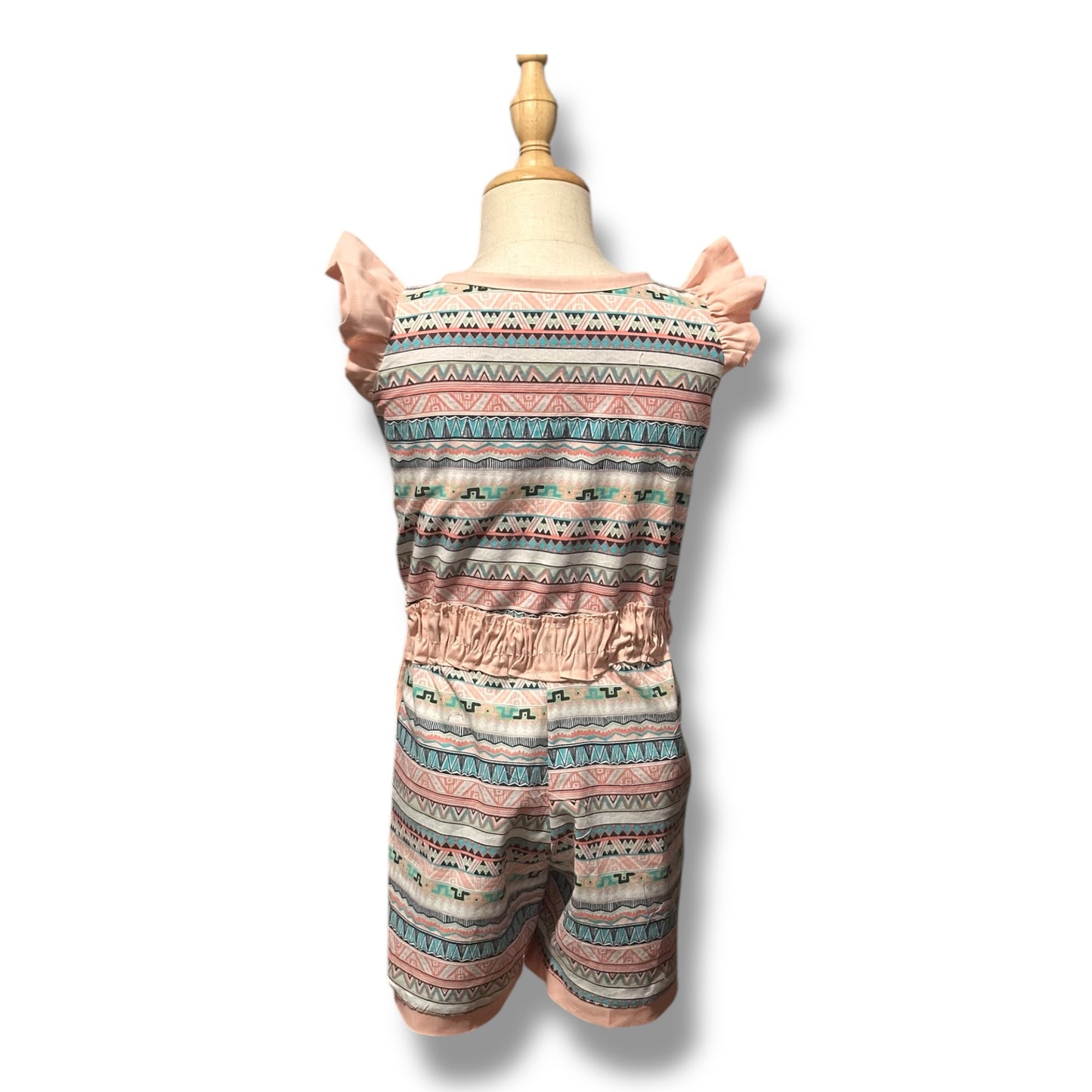 A back view of a handmade romper with a whimsical multicolour pattern, featuring flutter sleeves, a ruche waistband, and front button closure.