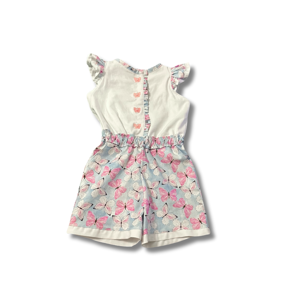 A handmade romper with a whimsical butterfly pattern, featuring flutter sleeves, a ruche waistband, and front button closure on a white background.