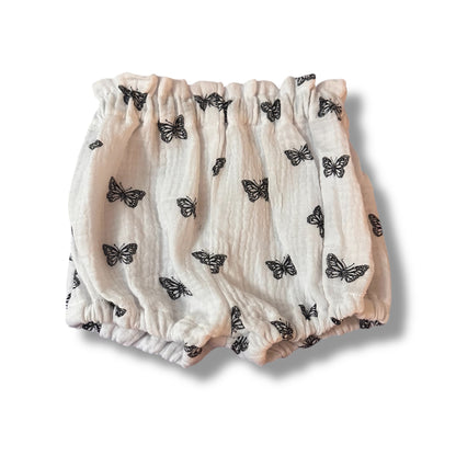 Handmade baby bloomers with a butterfly pattern on a white background