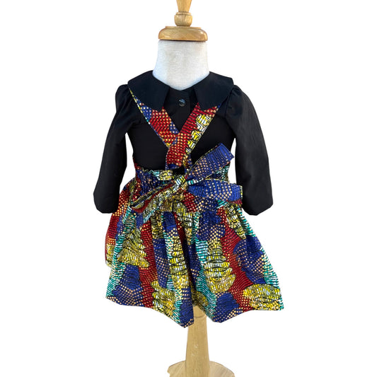 Back view of Mae Blouse and Leone skirt displayed on mannequin with bow tied in the back, handmade children’s clothing by Young World by Ruth