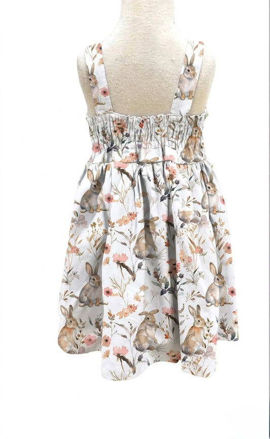 Dress with rabbit and floral pattern on a mannequin against a white background