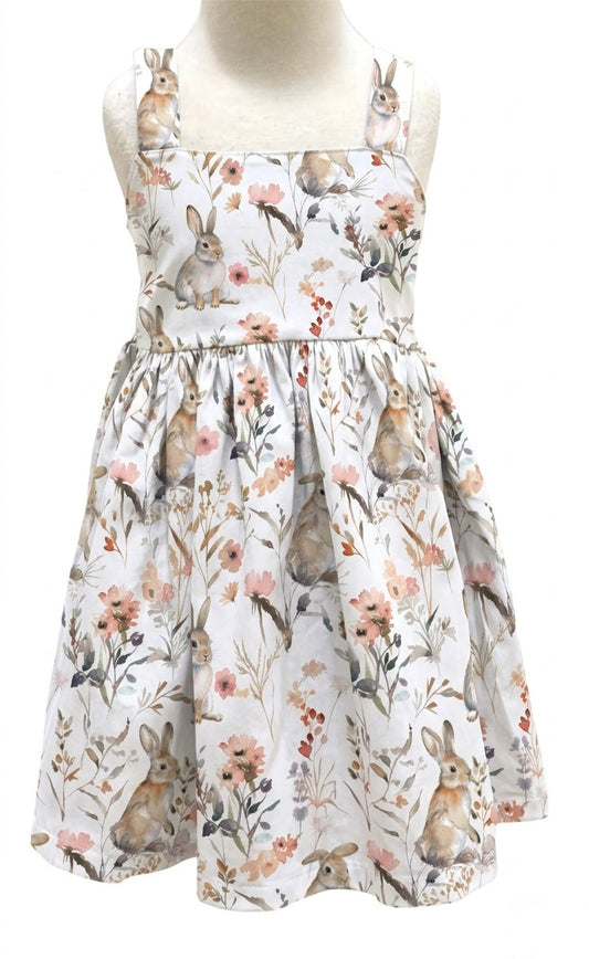 Dress with rabbit and floral pattern on a mannequin against a white background