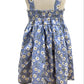 The back of a blue floral summer dress with an elasticised back on a mannequin.